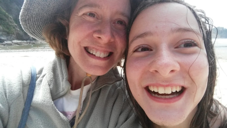 woman and younger woman selfie at beach
