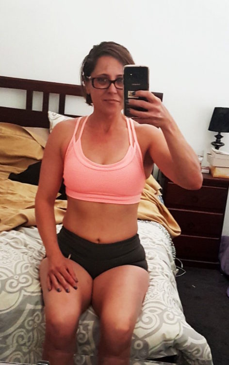 woman taking a photo of herself after working out