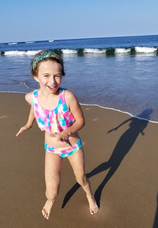 young girl playing on the beach