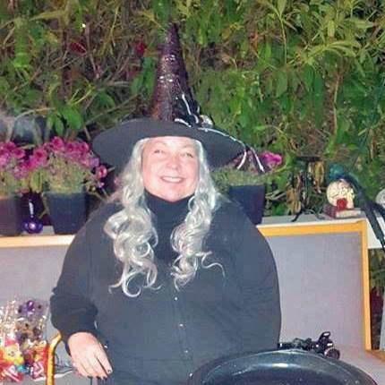 woman dressed as a witch with a cauldron
