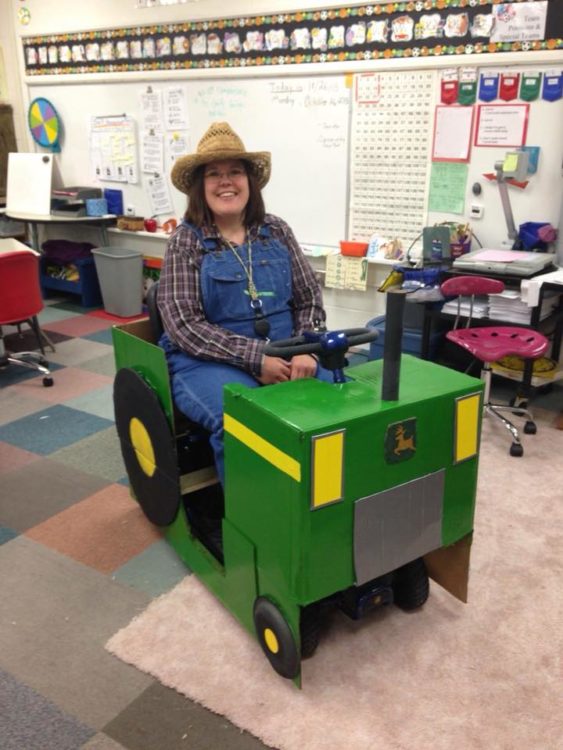 woman dressed as a farmer and riding a tractor
