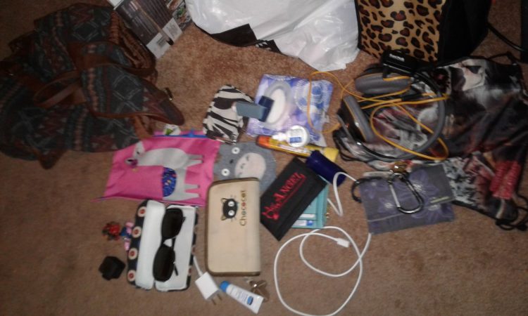 assortment of things on the floor, sunglasses, wallet, small cases