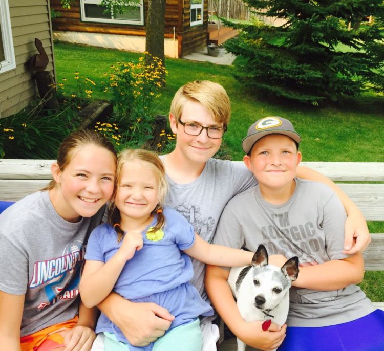 four siblings hugging