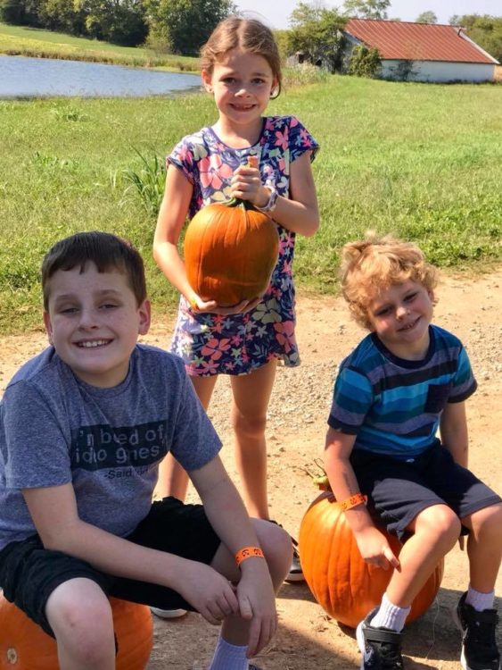 Three siblings at pumpkin patch