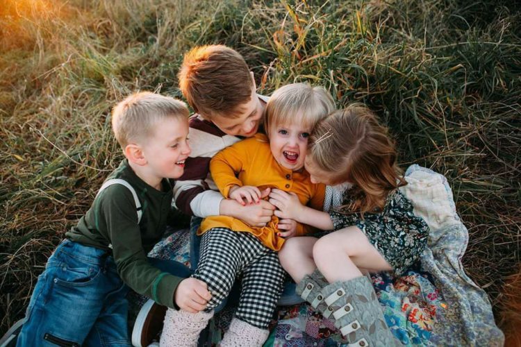 Four siblings hugging