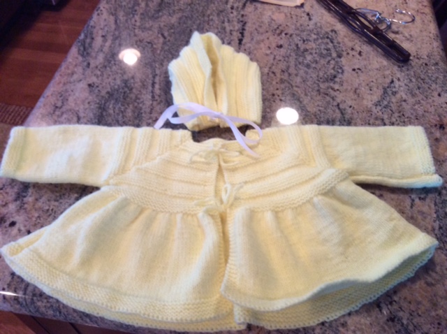 A yellow knit sweater that was donated to Ann's Place in Danbury Connecticut. 