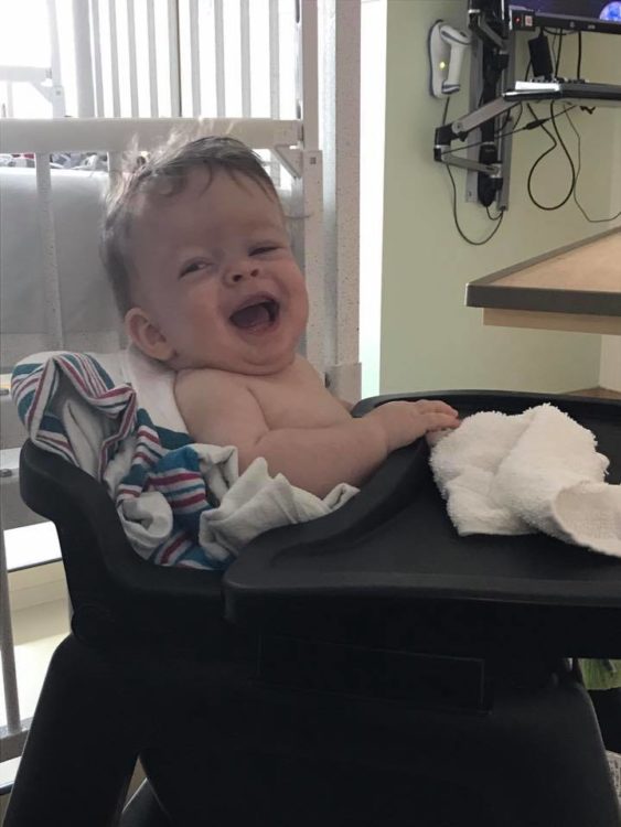 Baby sitting in high chair at a hospital