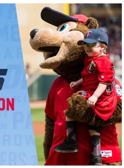 Little boy carried by Twins mascot