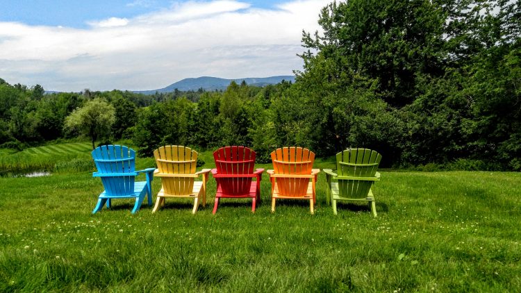 colorful chairs in a field in maine