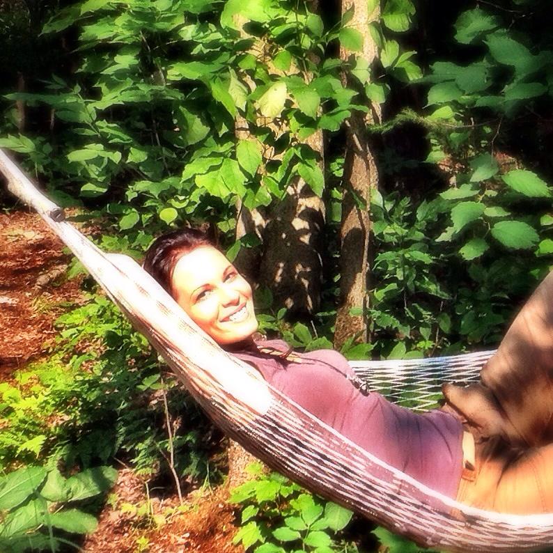 The writer laying in a hammock.
