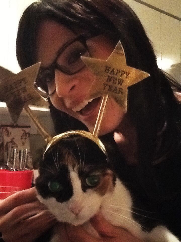 The writer and her cat, the cat wearing a New Year's Day headband.