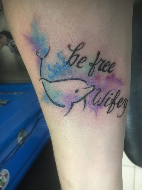 tattoo of a dolphin and the words "be free Wifey"