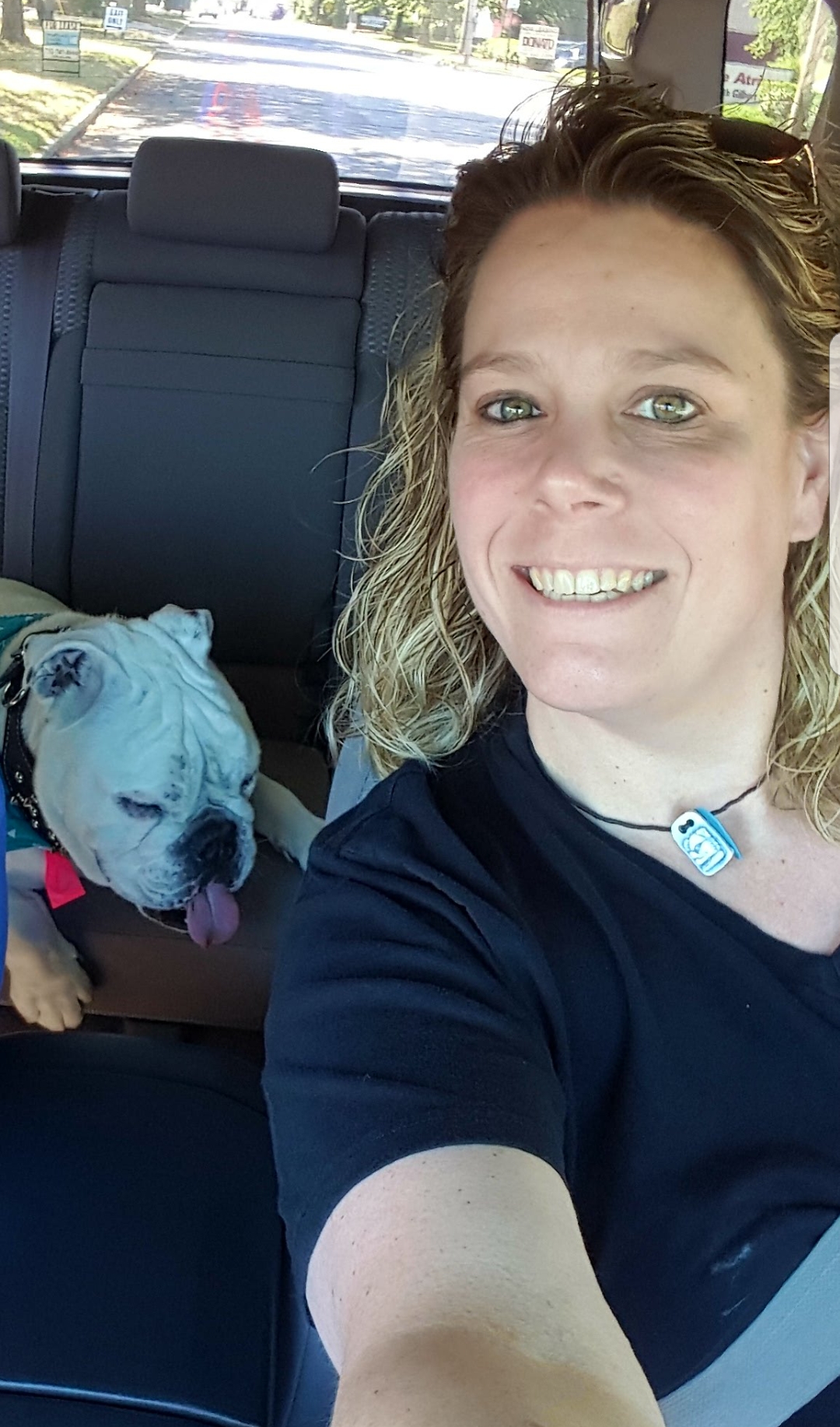The writer and her dog in a car.