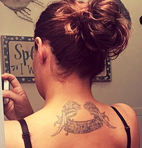 tattoo on the back of a woman's neck