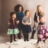 Group of girls modeling, one child has down syndrome