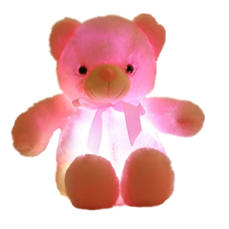 pink teddy bear that is glowing