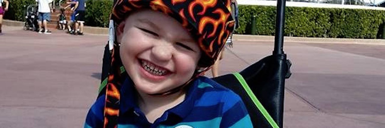 Leukodystrophy: What to Know When Your Child Gets Incurable Diagnosis author's son sitting in his wheelchair and smiling