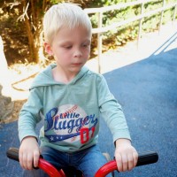A small boy riding a bike