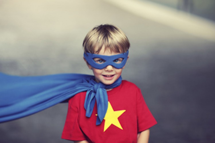 young boy in superhero costume