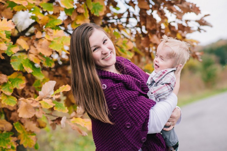 mother holding her young son outside