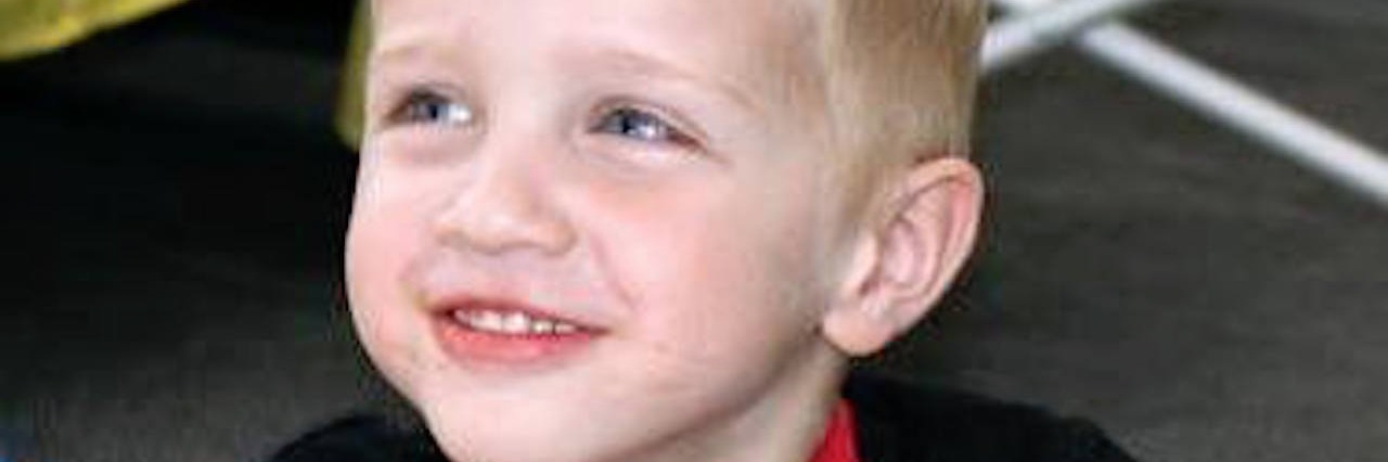 Guidance for Moms Still Learning to Navigate an Autism Diagnosis young boy smiling