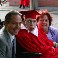 Michael and his wife with their son on his graduation day