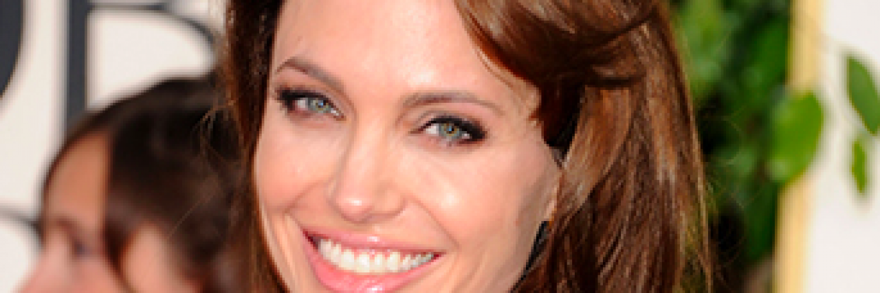 Study Shows Angelina Jolie's Personal Story Paid Off Angelina Jolie smiling in a bright green dress