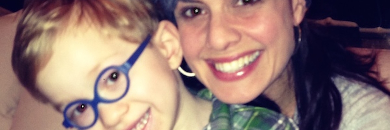 What I Wish I Knew When My Son Got Diagnosis of Prader-Willi Syndrome mom hugging toddler son in glasses