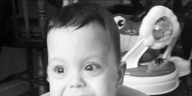 To the Repairman Who Truly Saw My Son young boy smiling and sitting in a highchair