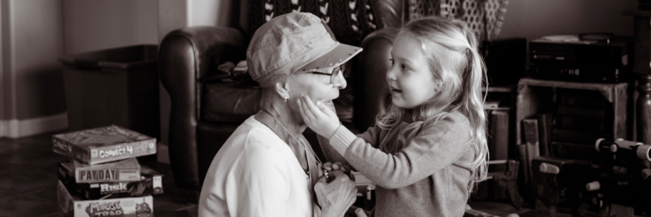 This Unforgettable Moment Happened Because My Daughter's Brain Is Imperfect Young girl holds older woman's face in her hands