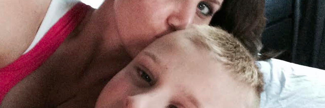 Only One Person Asked If He Could Help While My Son Was Convulsing Mother holding her son and kissing him on the head