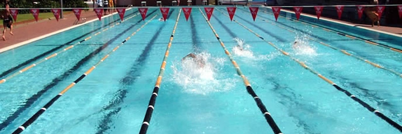 Father Responds With Laughter to Son With Autism Stripping in Public person swimming laps in a pool
