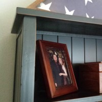 Bookshelf with author's picture and a wooden box holding the memories of her daughter