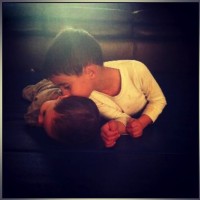 brother kissing his baby brother