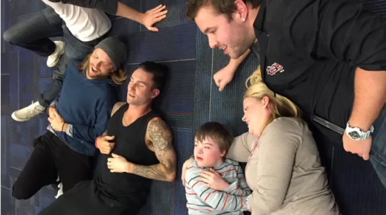 Adam Levine and Maroon 5 band lying on the floor with Christopher