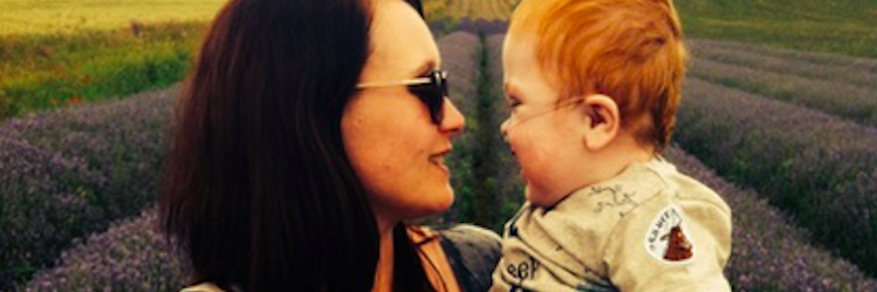 Rare Disease: When I Didn't Have Hope on My Son's Diagnosis Day Mom holding infant son in her arms outdoors