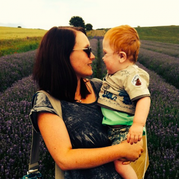 Mom holding infant son in her arms outdoors