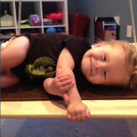 Boy lying on table, smiling