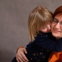 mom hugging young daughter