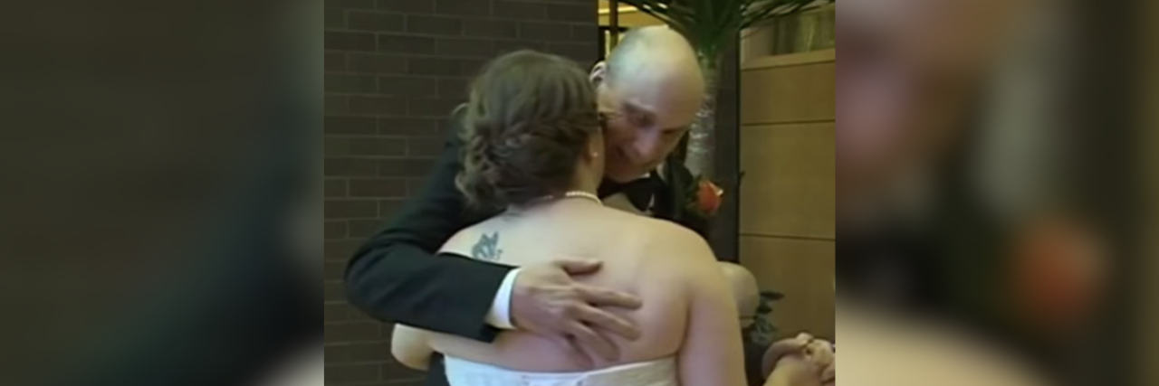 Father With Breast Cancer Walks Daughter Down the Aisle at Wedding Father hugging his daughter at her wedding