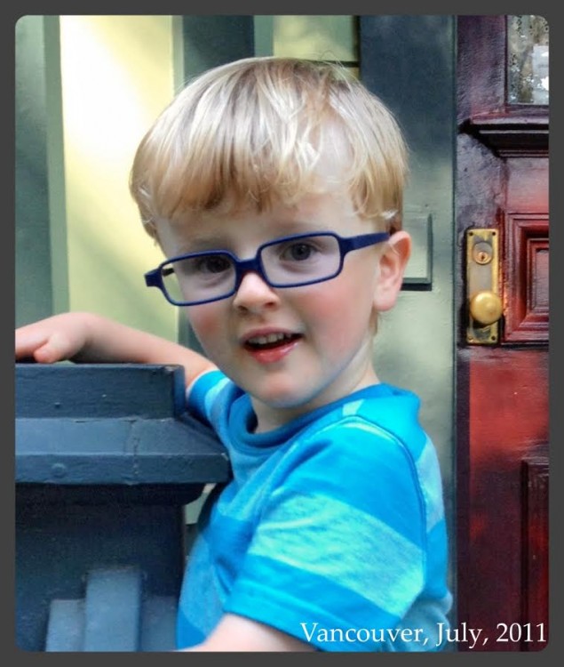 young boy smiling outside