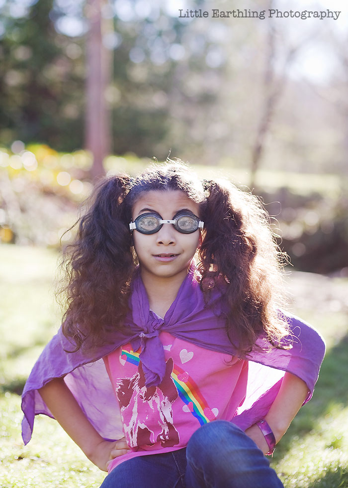 Avi wearing goggles and a purple cape