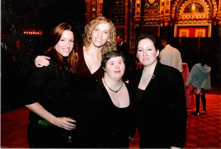 Author and her three sisters in front of a theater as adults