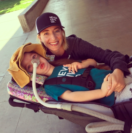 author smiling with daughter outside