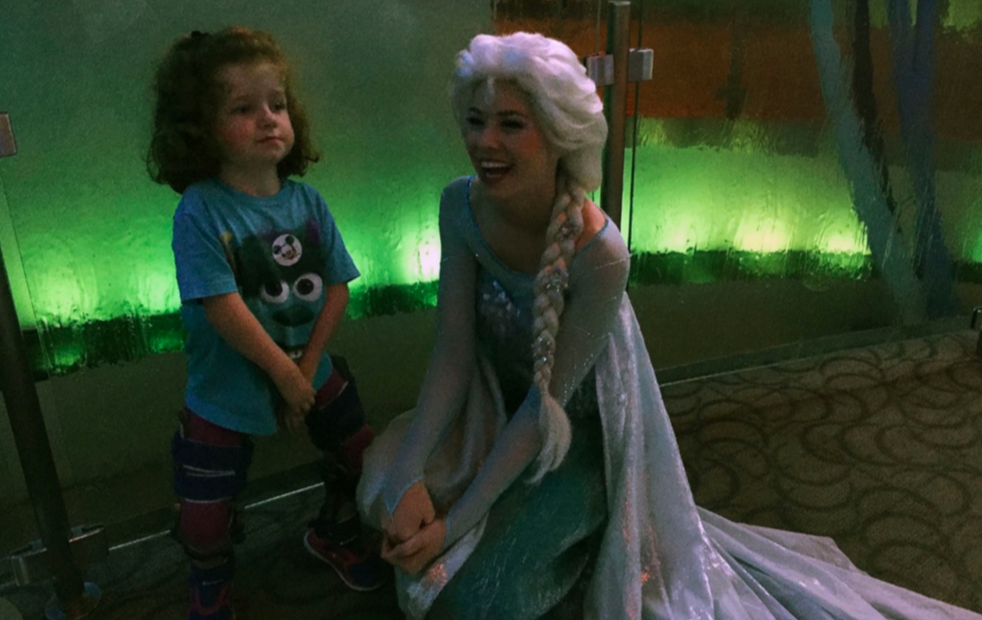 young girl with elsa from frozen at disneyland