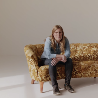 blind woman sitting on a couch and talking about what beauty means to her