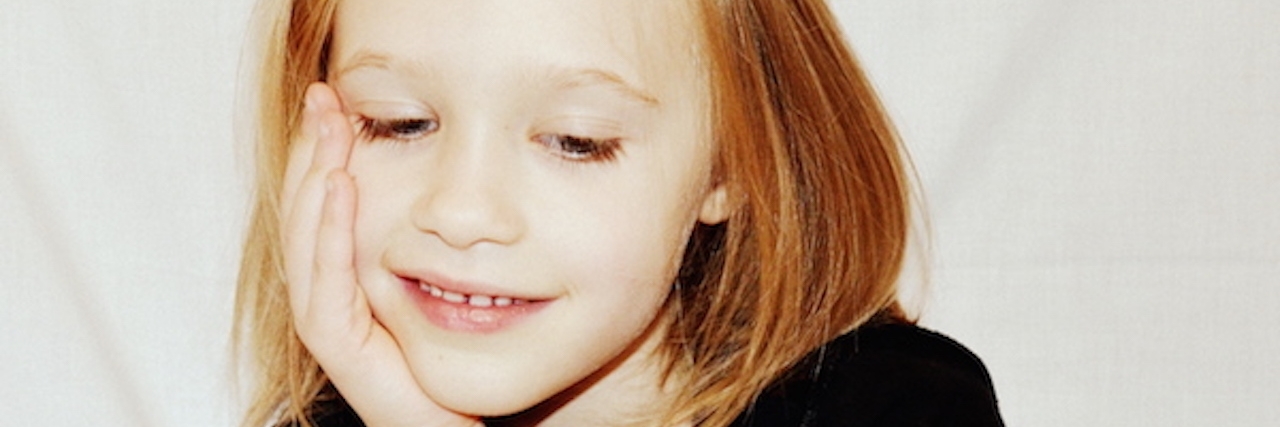 Autism: When My Daughter’s Classmate Said Something That Upset Me daughter with her hand leaning against her face