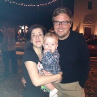 a mom, dad and small infant son smiling