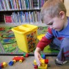 Little boy playing with a boy truck in the library