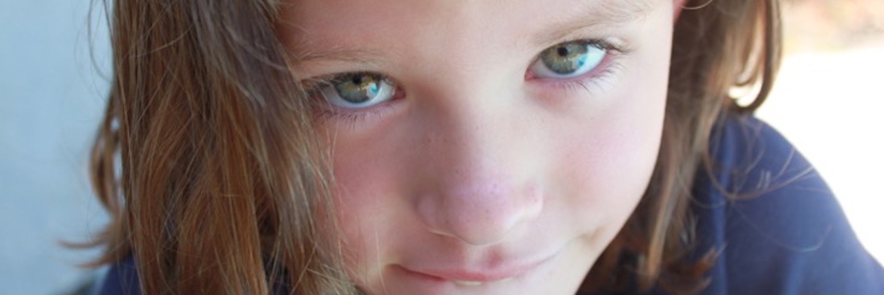adolescent girl looks into camera close-up
